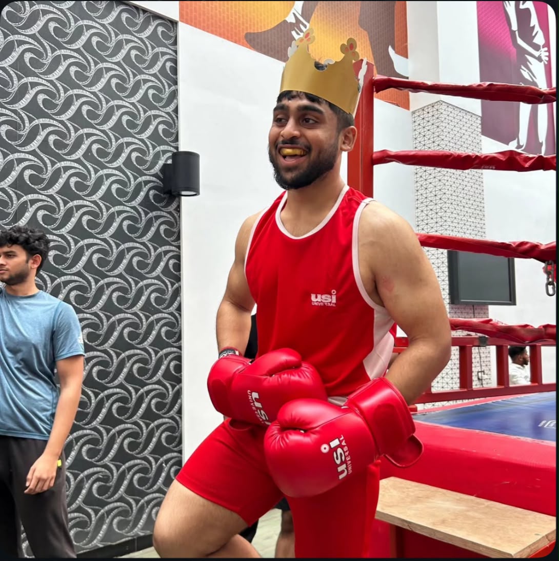 Mohi wearing boxing gloves beside the ring